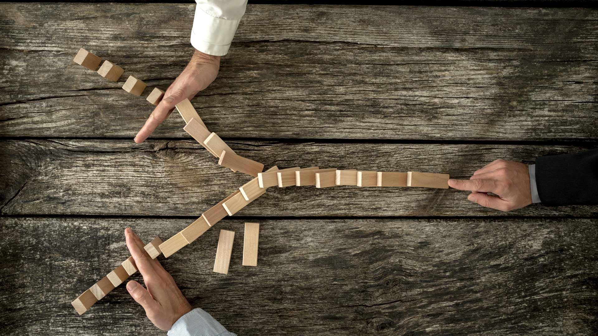 Compliance section image of three people interacting with dominos